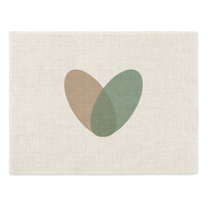 Toco Heart Placemat. Single linen effect placements featuring a graphic heart design made from two overlaid ovals, one in brown and one in green. Mustard & Gray Placemats.