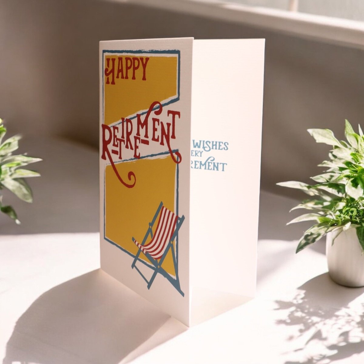 a card with a picture of a chair and a potted plant