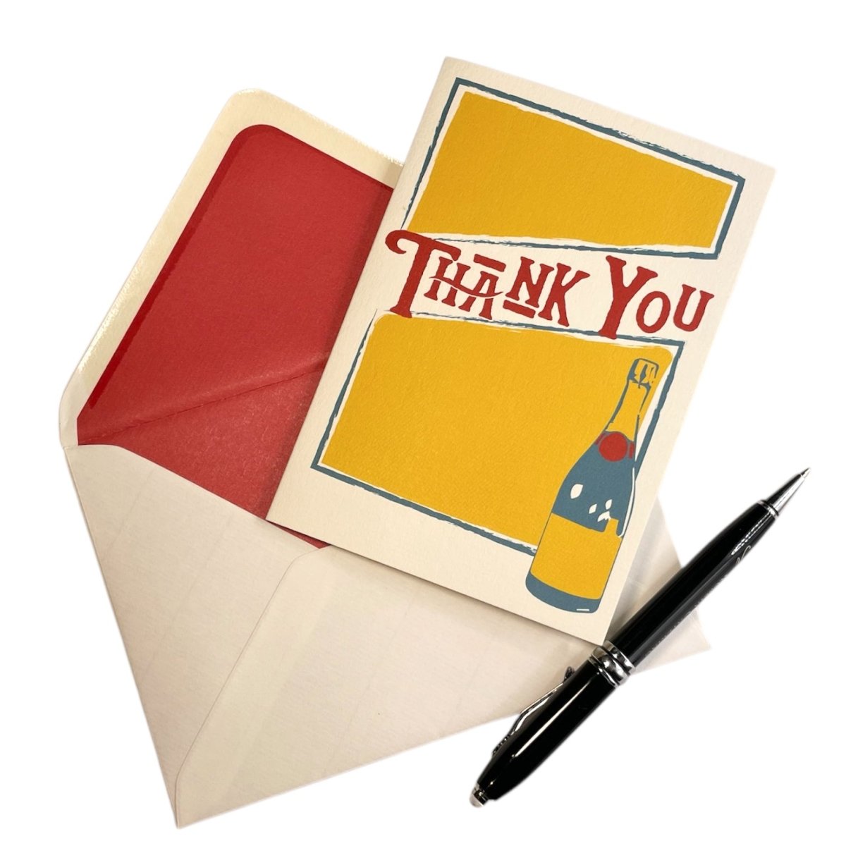 a thank you card with a pen on top of it