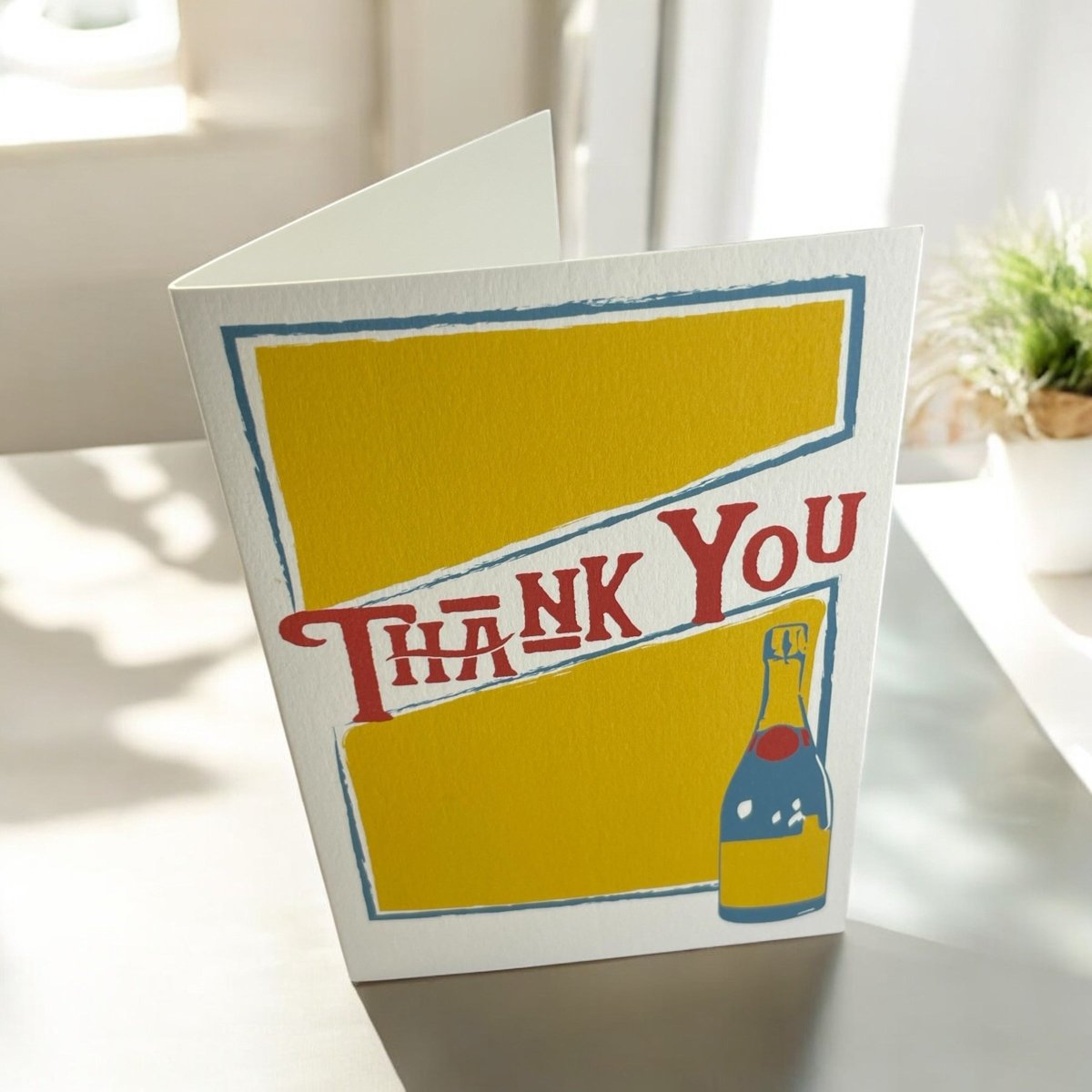 a thank you card with a bottle of wine