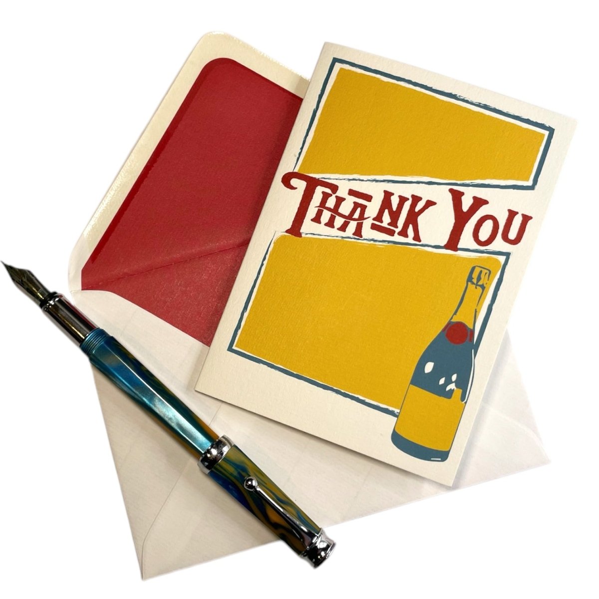 a thank you card with a pen and envelope