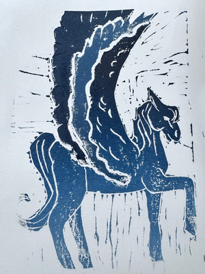 Blue linocut print of a winged horse, created during a Mustard & Gray printmaking workshop.