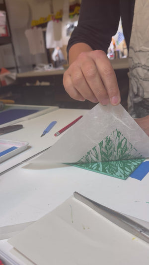 Video of jigsaw lino cutting print being pulled.