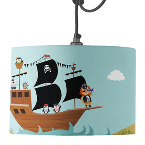 A blue drum lampshade featuring a pirate ship, penguin pirates, lion captain peg leg desert Island and treasure design on a pendant fitting.