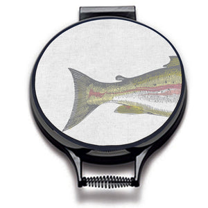  painted illustration of a salmon fish with green and pink colouring print on a beige linen circular hob cover with black hemming. fish tail of the hob pad. Pictured on metal cooker lid on an isolated background. Mustard and Gray Severn Salmon Circular Hob Cover