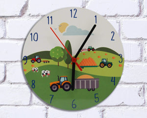 Farm themed childrens clock for a kids bedroom or nursery with tractors, cows, bales, frees, hills and clouds  on the clock face. Black hands with second hand on a whote brick wall. From Mustard and Gray