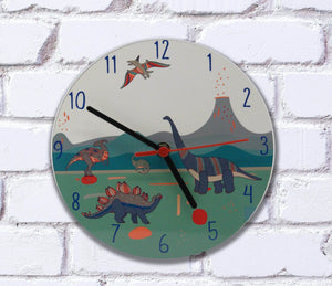 Dinosaur themed childrens clock for a kids bedroom or nursery with dinosaurs and volcanos on the clock face. Black hands with second hand. From Mustard and Gray