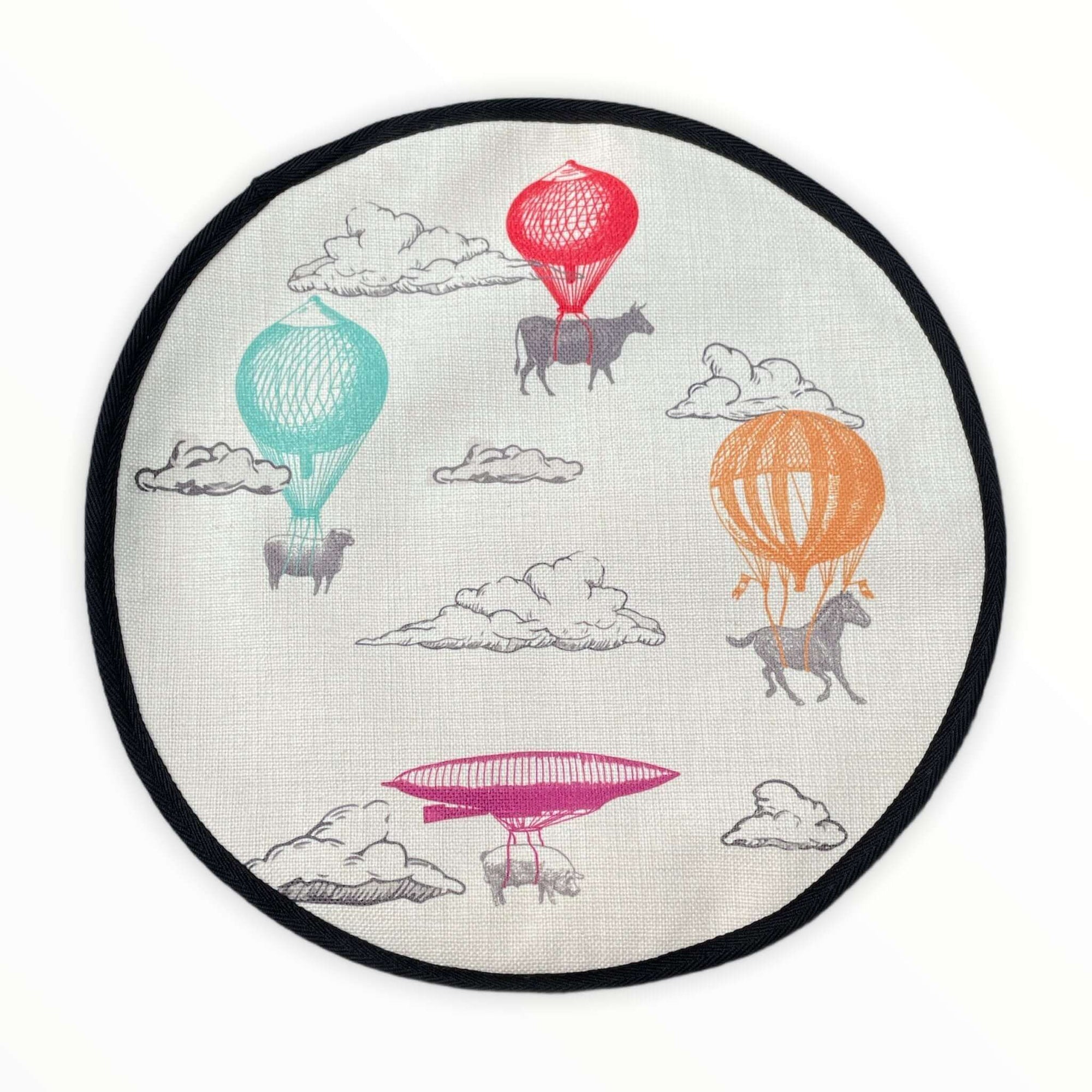 Farm High Life cow, sheep, horse and pig sketch drawings with colourful hot air balloons print on a beige linen circular aga cover with black hemming. Mustard and Gray