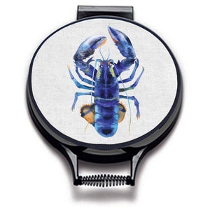 blue lobster watercolour painting on a beige linen circular hob cover with black hemming. Pictured on metal cooker lid on an isolated background. Mustard and Gray