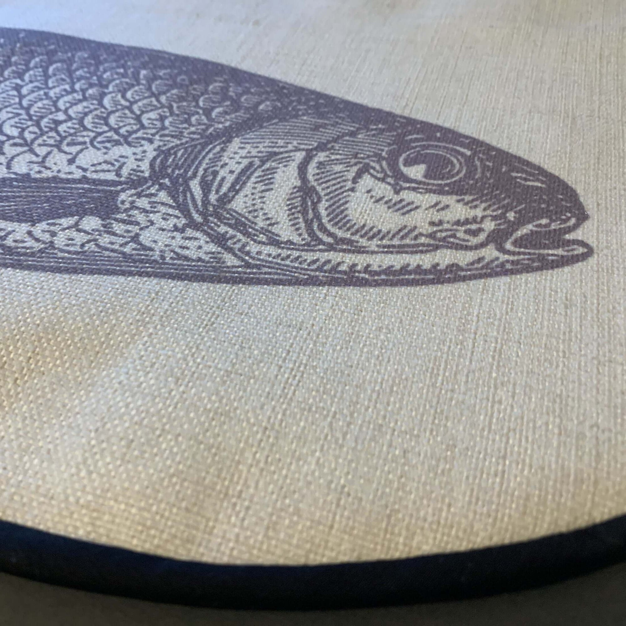 Close up of grey fish illustration printed onto neutral linen  hob cover from Mustard and Gray