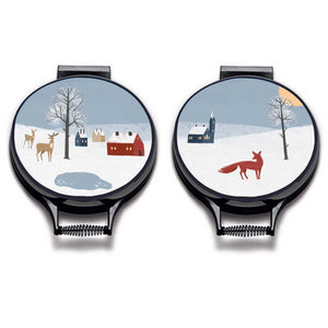 Set of Two. winter fox scandi modern print on a beige whith village scene including blue sky, a red fox, deer houses, church and pond linen circular hob cover with black hemming. Pictured on metal cooker lid on an isolated background. Mustard and Gray